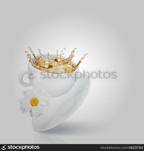 Chamomile tea. White cup of tea with chamomile flower