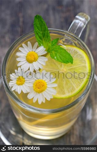 chamomile tea with lemon on wooden table