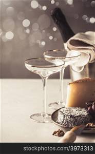 Champagne and cheese plate on concrete background, copyspace