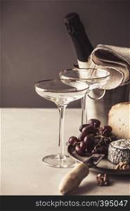 Champagne and cheese plate on concrete background, copyspace. Champagne and cheese plate on concrete background