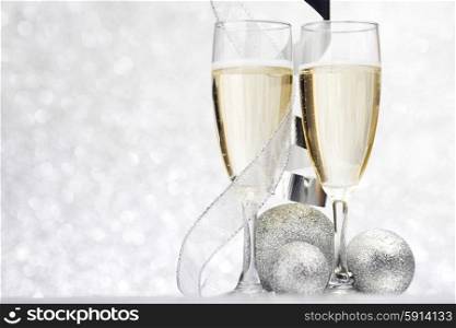 Champagne and decor on silver bokeh background