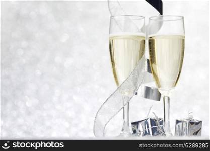 Champagne and decor on silver bokeh background