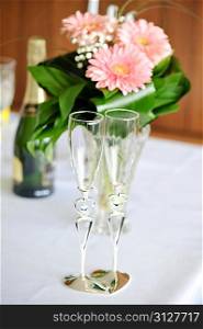 champagne and pink gerbera on table in wedding day