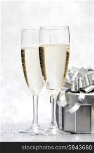 Champagne and present on silver bokeh background