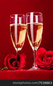 Champagne and red heart shaped roses on red background. Champagne and red roses