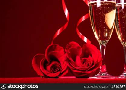Champagne and roses. Champagne and heart shaped roses with copy space