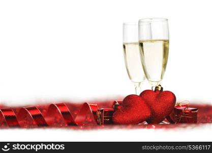 Champagne and valentines day decoration on red glitter background