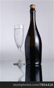 Champagne bottle with chilled class on a smooth light surface
