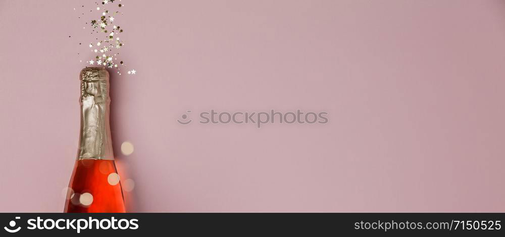 Champagne bottle with christmas decoration on darkbackground. Flat lay. Party concept.