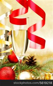 Champagne, fir tree, christmas decor and gifts on golden background