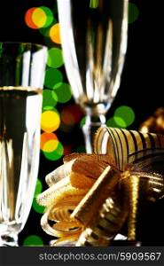 Champagne glasses and gifts ready to bring in the new year. Champagne glasses