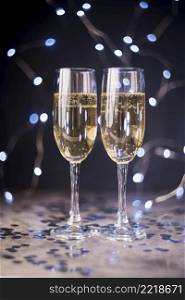champagne glasses table with silver confetti nightclub