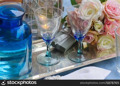 Champagne glasses. Table with two empty champagne glasses with rose flowers