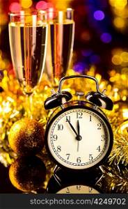champagne with clock and christmas toys on blurred background