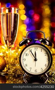 champagne with clock and christmas toys on blurred background