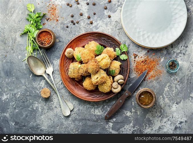 Champignon mushrooms in breadcrumbs.Breaded mushrooms or deep-fried mushrooms. Champignon mushrooms deep-fried