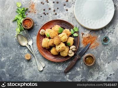 Champignon mushrooms in breadcrumbs.Breaded mushrooms or deep-fried mushrooms. Champignon mushrooms deep-fried