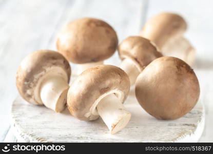 Champignon mushrooms on the wooden board