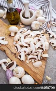 champignon mushrooms on wooden cutting board at domestic kitchen.. champignon mushrooms on wooden cutting board at domestic kitchen