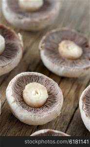 Champignon mushrooms sliced on wooden table
