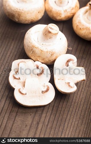 Champignons and slices on the wooden table closeup
