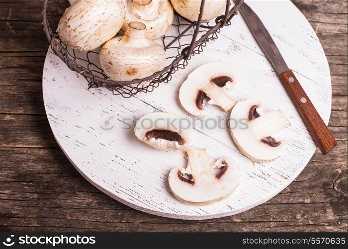 champignons in basket on the wooden board