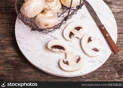 champignons in basket on the wooden board