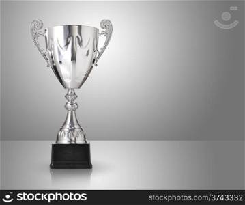 champion silver trophy over grey background