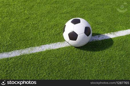 Championship football or soccer ball on a green sports field placed on a white line on the turf in evening light with copy space