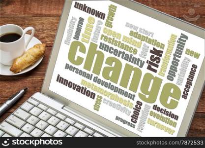 change word cloud on laptop screen with a cup of coffee