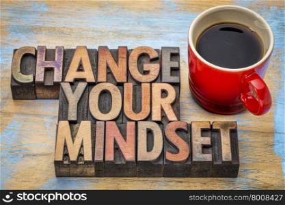 change your mindset - motivational text in vintage letterpress wood type printing blocks stained by color inks with a cup of coffee