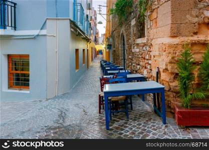 Chania. Greek Street Cafe.. Tables and chairs of restaurant on the street. Chania. Crete. Greece.
