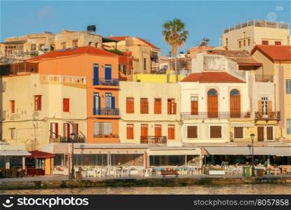 Chania. The old harbor.. Multi-colored facades of old medieval houses in the old harbor of Chania. Greece. Crete.