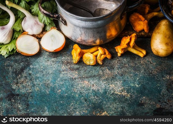 Chanterelles ingredients and old cooking pot on rustic background, top view, border