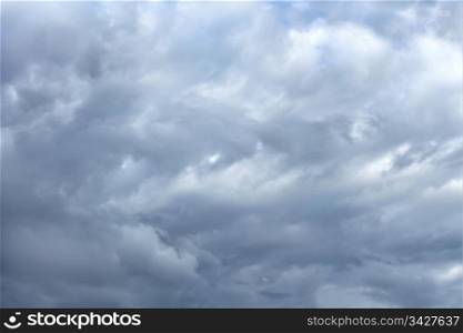Chaotic accumulation of different gray clouds in windy weather