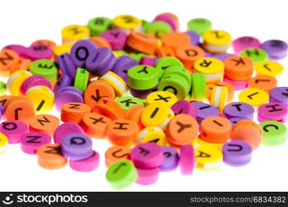 Chaotically folded multicolor circles with letters written on them on a white background