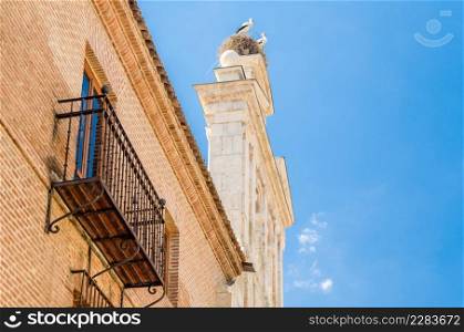 Chapel of San Ildefonso in Alcala de Henares, with storks on the tower, Madrid province, Spain