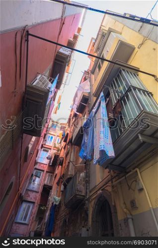 characteristic narrow street with hanging clothes, Naples, Italy