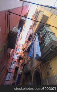 characteristic narrow street with hanging clothes, Naples, Italy