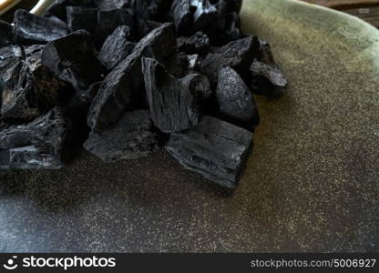 Charcoal for grill on a ceramic plate texture