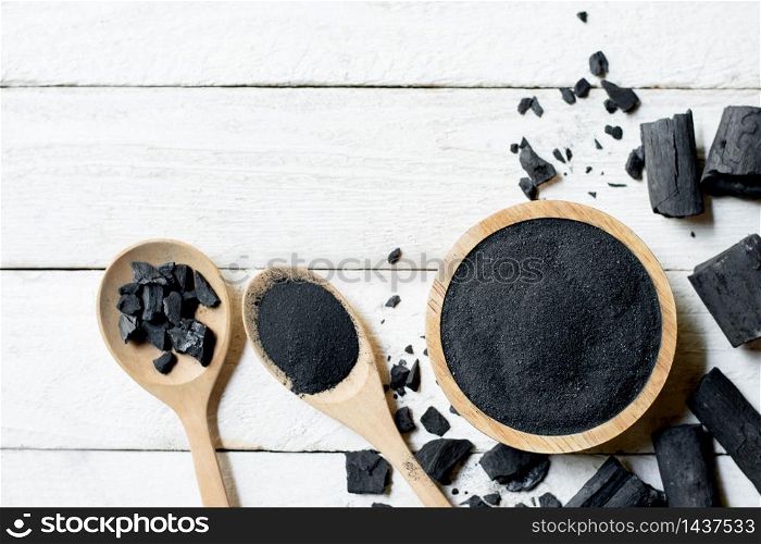 Charcoal powdered wood, put on a cup, placed on a white table.