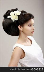 Charisma. Profile of Independent Woman with Futuristic Hairstyle and Orchid Flowers