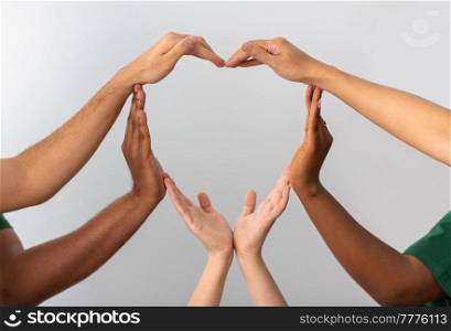 charity, love and valentine&rsquo;s day concept - close up of hands making heart gesture over grey background. close up of hands making heart gesture