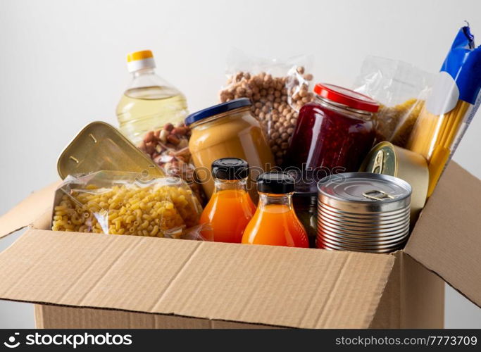 charity, support and concept - close up of food in donation box. close up of food in donation box