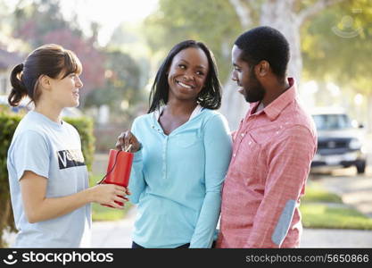 Charity Worker Collecting Sponsorship From Couple In Street