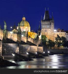 Charles Bridge and Old Town Bridge Tower on the Vltava river in Prague at night. Karluv Most. Czech Republic