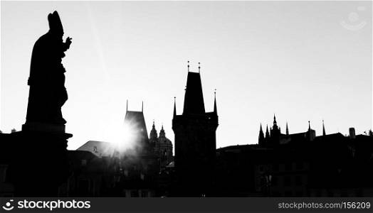 Charles Bridge at sunrise, Prague, Czech Republic. Dramatic statues and medieval towers. Silhouette photography style. Black and white. Charles Bridge at sunrise, Prague, Czech Republic. Statues and towers silhouettes