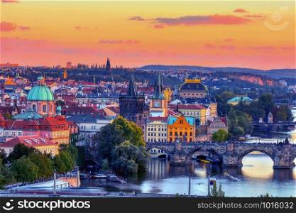 Charles bridge, Karluv most and Lesser town tower, Prague in autumn at sunrise, Czech Republic.