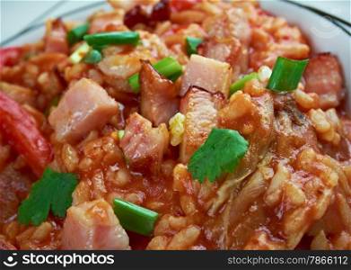 Charleston red rice - Savannah Red Rice rice dish commonly Southeastern coastal regions of Georgia and South Carolina.cooking white rice with tomatoes , bacon , pork sausage.