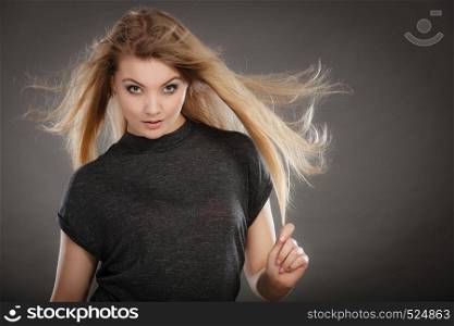 Charm and flirt concept. Lovely charming lady portrait with flirting eye looking and smile. Joyful happy young blonde woman model.. Smiling joyful lady in trendy fashion look.